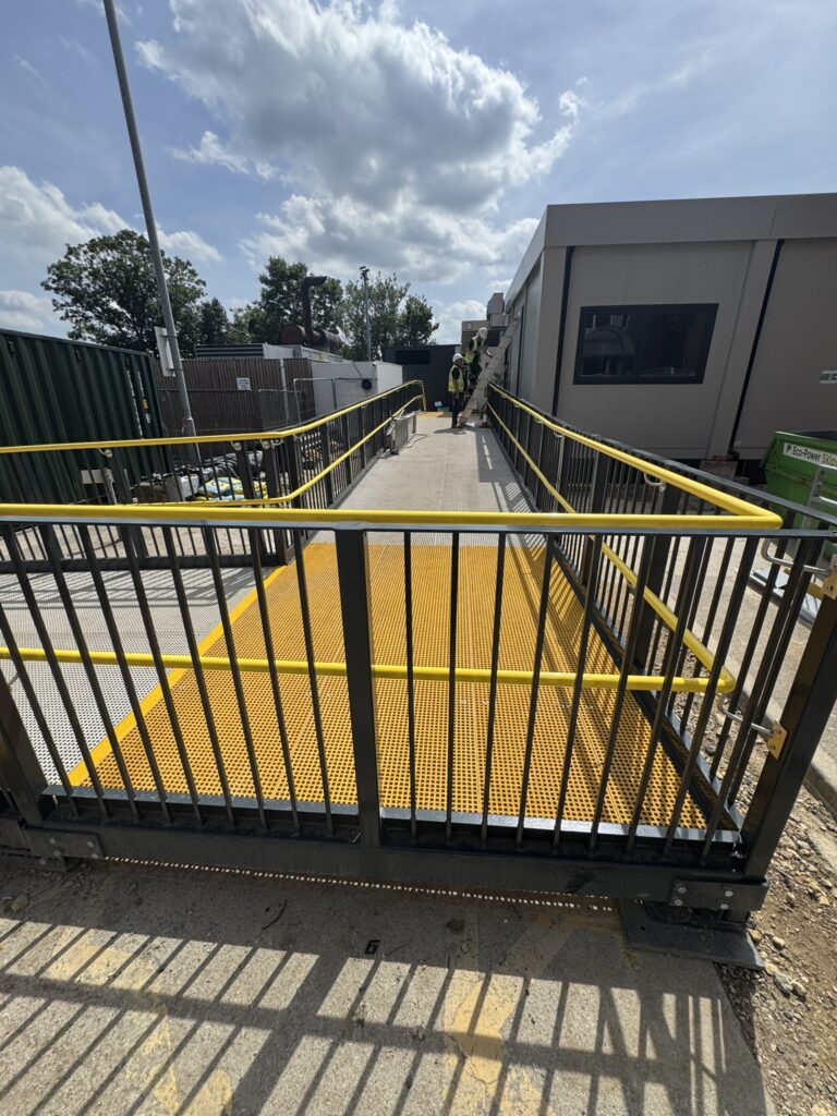 Bespoke steel access ramp with GRP decking and handrails, designed and manufactured by Telford Fabrications